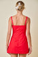 Sleeveless Front Twist Poplin Romper Dress with Overlay Skirt in Red